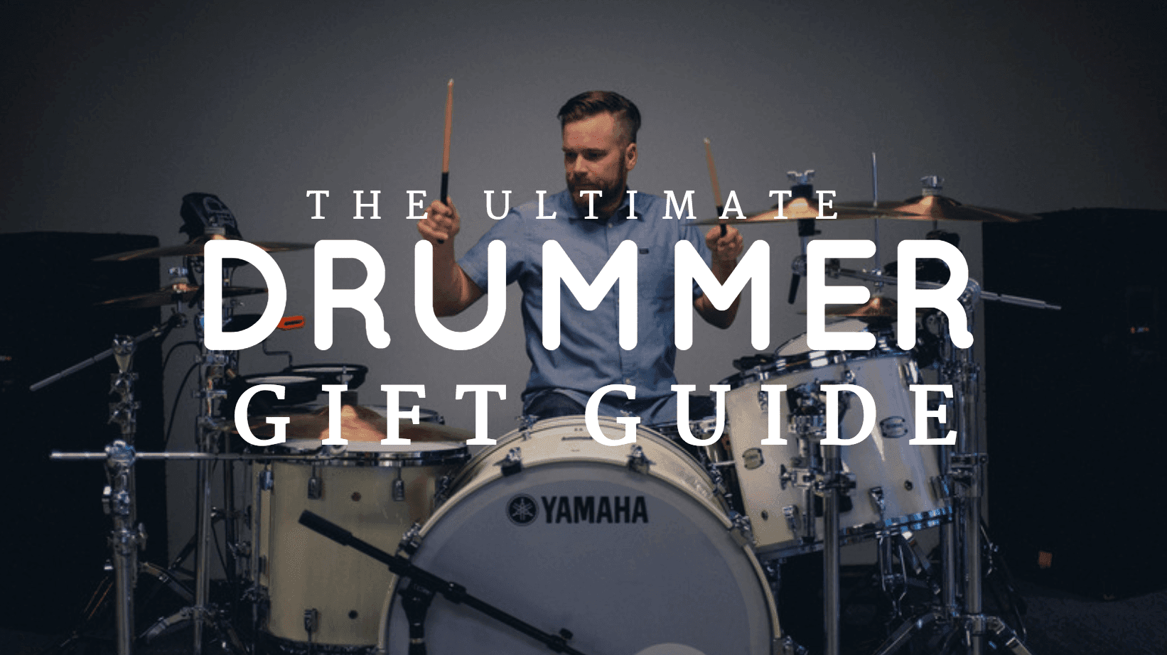 A title slide with a picture of a drummer playing drums. The text says "The ultimate drummer gift guide."
